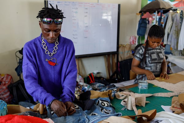 Designers work in the remanufacturing space at the OR Foundation to upcycle textile waste in Accra, Ghana, Thursday, Oct. 24, 2024. (AP Photo/Misper Apawu)