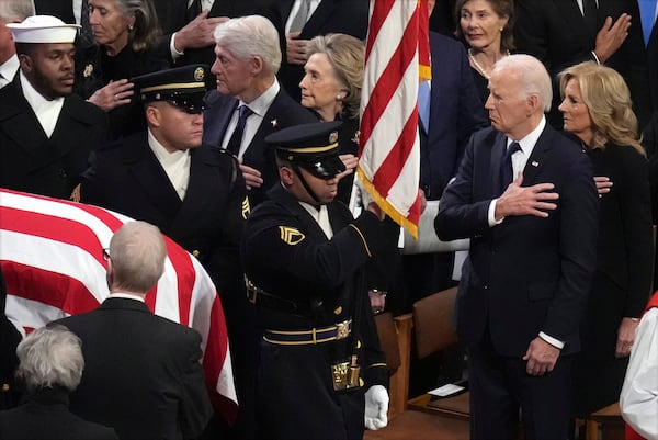 President Joe Biden, first lady Jill Biden and other past presidents watch as a body bearer team carries the casket of former President Jimmy Carter during the state funeral at Washington National Cathedral in Washington, Thursday, Jan. 9, 2025. (AP Photo/Jacquelyn Martin)