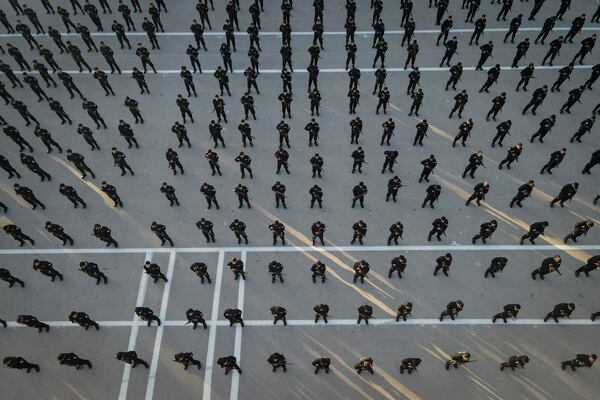 Recruits for the new government's police force stand in formation during a training and graduation session at the Police College in Damascus, Syria, Tuesday Jan. 14, 2025.(AP Photo/Omar Albam)