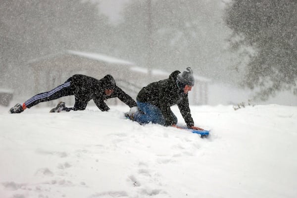 Families gathered at Bayview Park to enjoy the six plus inches of snow that has accumulated on Tuesday, Jan. 21, 2025, in Pensacola, Fla. (Luis Santana/Tampa Bay Times via AP)