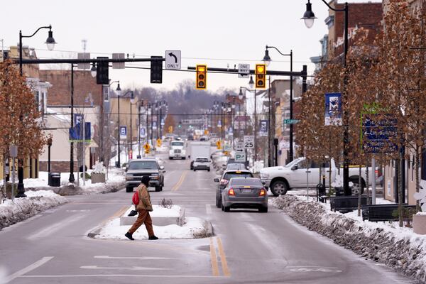 A pedestrian crosses Central Avenue through downtown, Tuesday, Jan. 14, 2025, in Middletown, Ohio. The city is the hometown of Vice President-elect JD Vance.(AP Photo/Kareem Elgazzar)