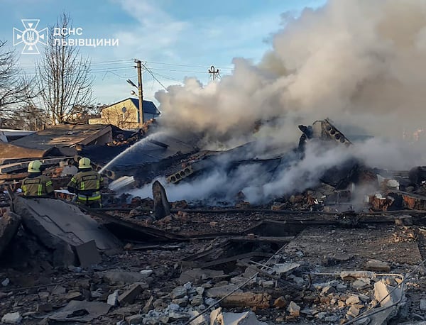 In this photo provided by the Ukrainian Emergency Service, emergency services personnel work to extinguish a fire following a Russian rocket attack in Lviv, Ukraine, Sunday, Nov. 17, 2024. (Ukrainian Emergency Service via AP)