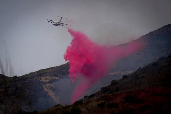 Retardant is dropped onto the Franklin Fire Wednesday, Dec. 11, 2024, in Malibu, Calif. (AP Photo/Eric Thayer)