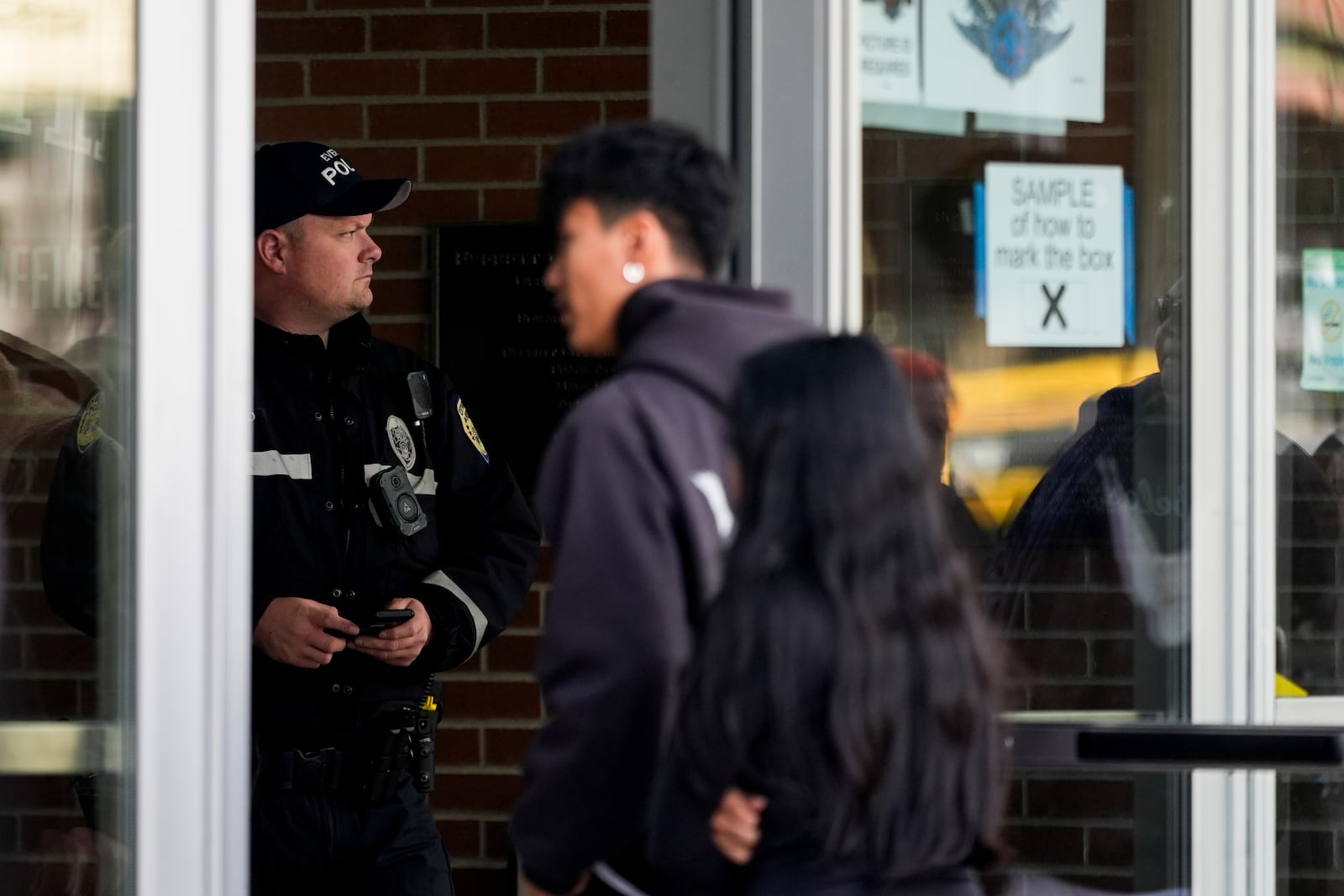 An Everett police officer stands inside the Angel of the Winds Arena as Boeing employees arrive to vote on a new contract offer from the company, Monday, Nov. 4, 2024, in Everett, Wash. (AP Photo/Lindsey Wasson)