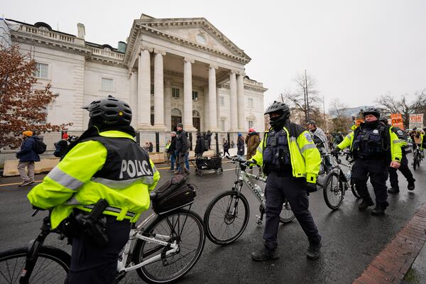 Police move past the Daughters of the American Revolution National Headquarters building during the People's March, Saturday, Jan. 18, 2025, in Washington. (AP Photo/Mike Stewart)