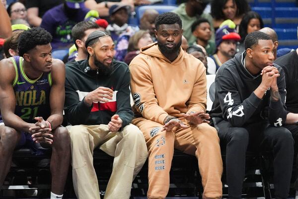 New Orleans Pelicans forward Zion Williamson, second right, and forward Brandon Ingram, second left, sit on the bench with center Yves Missi (21) and forward Jamal Cain in the second half of an NBA basketball game in New Orleans, Wednesday, Nov. 27, 2024. The Raptors won 119-93. (AP Photo/Gerald Herbert)