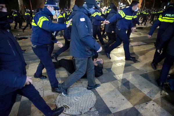 Police push protesters away after destroying a tent camp on a street during a rally against the results of the parliamentary elections amid allegations that the vote was rigged in Tbilisi, Georgia, on Tuesday, Nov. 19, 2024. (AP Photo/Zurab Tsertsvadze)