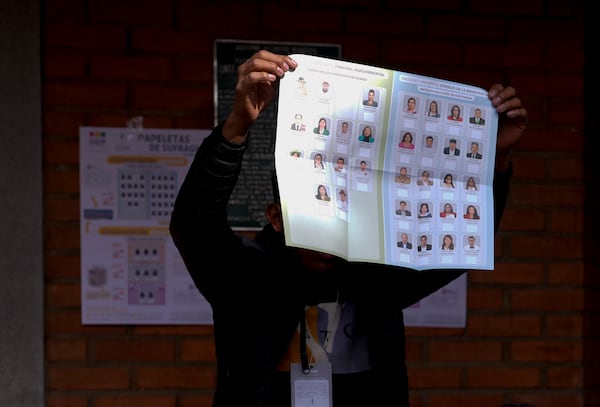 An electoral delegate shows an unmarked ballot at a polling station during judicial elections in Jesus de Machaca, Bolivia, Sunday, Dec. 15, 2024. (AP Photo/Juan Karita)