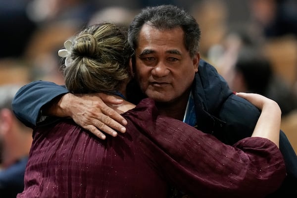 Toeolesulusulu Cedric Schuster, Samoa environment minister, right, embraces an attendee during a closing plenary session at the COP29 U.N. Climate Summit, Sunday, Nov. 24, 2024, in Baku, Azerbaijan. (AP Photo/Rafiq Maqbool)