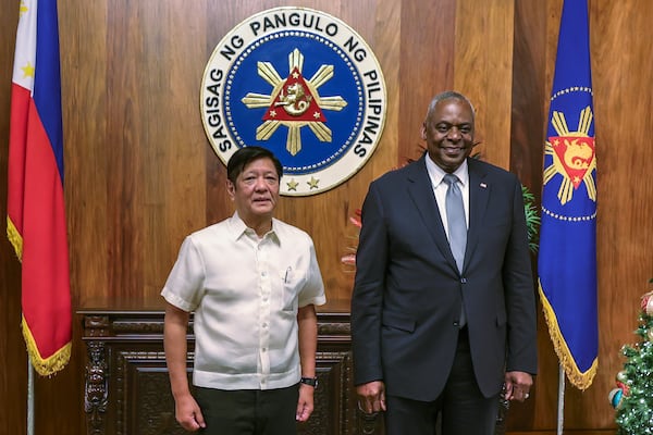 U.S. Defense Secretary Lloyd Austin, right, and Philippine President Ferdinand Marcos Jr. pose for a photograph during a courtesy call at the Malacanang Palace in Manila, Philippines Monday, Nov. 18, 2024. (AP Photo/Gerard Carreon, Pool)