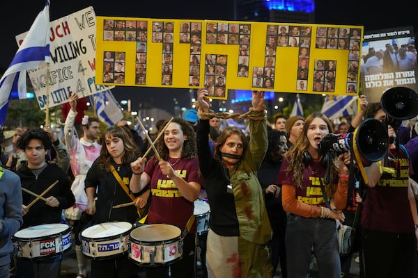 People shout slogans during a protest against Prime Minister Benjamin Netanyahu's government and call for the release of hostages held in the Gaza Strip by the Hamas militant group, in Tel Aviv, Israel, Saturday Nov. 30, 2024.(AP Photo/Ohad Zwigenberg)