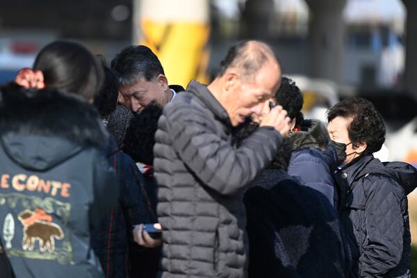 Family members of the passengers on a plane which burst into flames, weep at the Muan International Airport in Muan, South Korea, Sunday, Dec. 29, 2024. (Park Ki-woong/Newsis via AP)