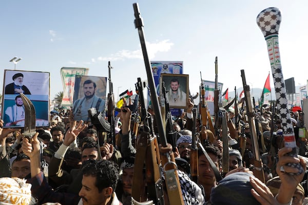 Houthi supporters raise their machine guns during an anti-Israel rally in Sanaa, Yemen, Friday, Jan. 10, 2025. (AP Photo/Osamah Abdulrahman)