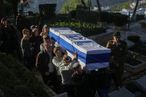 Israeli soldiers and relatives carry the flag-draped casket of 1st Sgt. Hillel Diener, who was killed in combat in the Gaza Strip, during his funeral at the Mount Herzl military cemetery in Jerusalem, Israel, Tuesday, Dec. 24, 2024. (AP Photo/Ohad Zwigenberg)