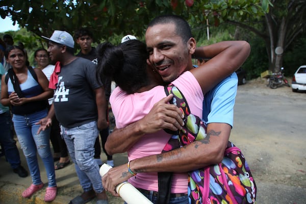 Wilmer Garcia is embraced after his release from the Yare 3 prison, in San Francisco de Yare, Venezuela, Saturday, Nov. 16, 2024. Attorney General Tarek William Saab announced the release of some of those who were detained during a government crackdown following anti-government protests against the results of the presidential election. (AP Photo/Cristian Hernandez)