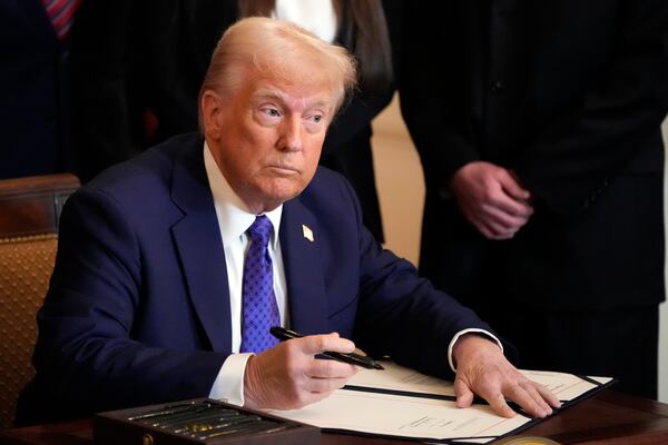 President Donald Trump signs the Laken Riley Act during an event in the East Room of the White House, Wednesday, Jan. 29, 2025, in Washington. (AP Photo/Alex Brandon)