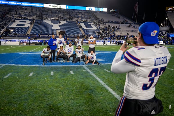 Kansas punter Grayden Addison (37) snaps a shot of his team mates after Kansas defeated BYU, in an NCAA college football game Saturday, Nov. 16, 2024, in Provo. (AP Photo/Rick Egan)