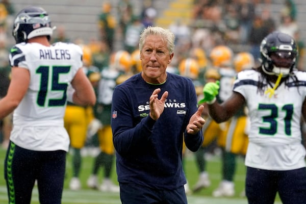 FILE 0 Seattle Seahawks Pete Carroll talks to his players before a preseason NFL football game against the Green Bay Packers, Saturday, Aug. 26, 2023, in Green Bay, Wis. (AP Photo/Kiichiro Sato, File)