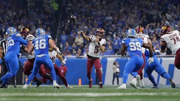 Washington Commanders quarterback Jayden Daniels (5) throws against the Detroit Lions during the first half of an NFL football divisional playoff game, Saturday, Jan. 18, 2025, in Detroit. (AP Photo/Rey Del Rio)