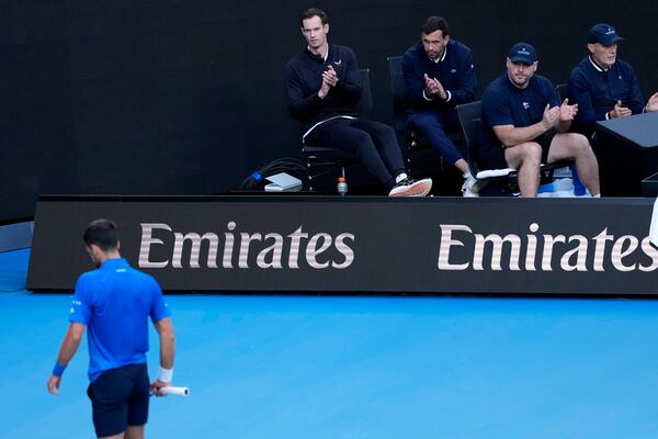 Andy Murray, top left, coach of Novak Djokovic of Serbia watches his first round match against Nishesh Basavareddy of the U.S. at the Australian Open tennis championship in Melbourne, Australia, Monday, Jan. 13, 2025. (AP Photo/Asanka Brendon Ratnayake)