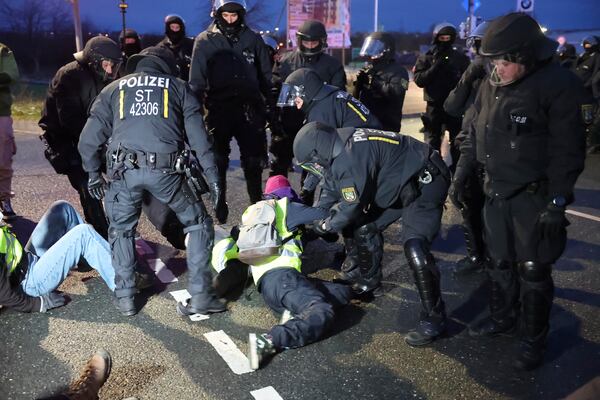 Police clear a sit-in blockade at a demonstration against the AfD's national party conference Saturday, Jan. 11, 2025, in Saxony, Riesa, Germany. (Jan Woitas/dpa via AP)