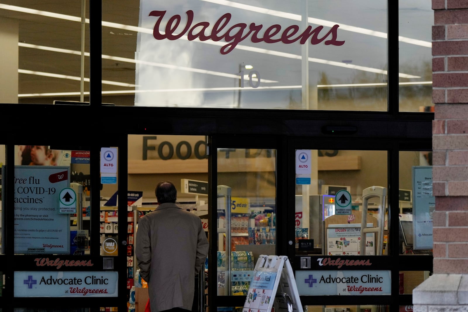 A customer walks to a Walgreens store in Wheeling, Ill., Tuesday, Oct. 15, 2024. (AP Photo/Nam Y. Huh)