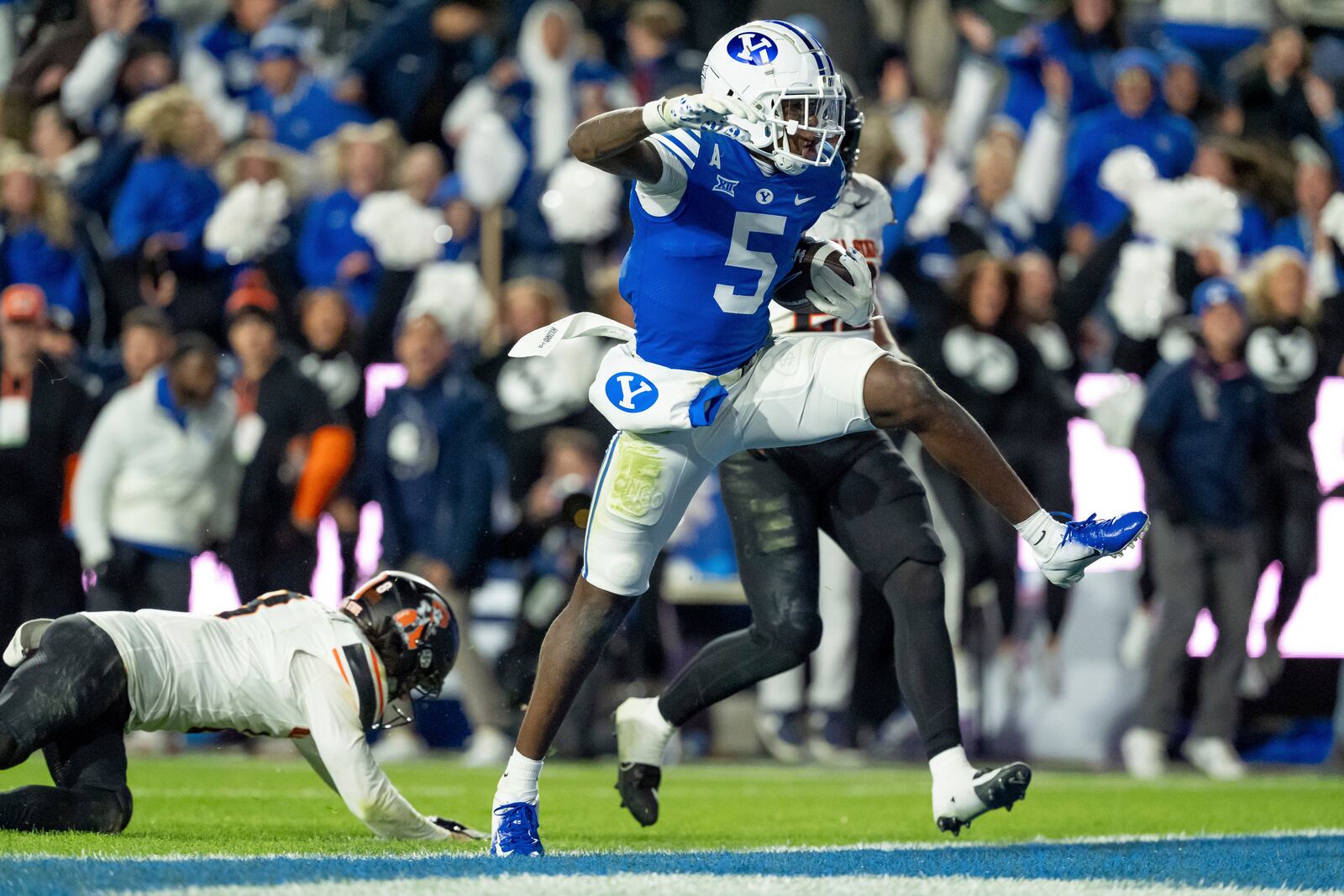 BYU wide receiver Darius Lassiter (5) runs the ball in for a touchdown in the final seconds of the second half of an NCAA college football game, Friday, Oct. 18, 2024, in Provo, Utah. (AP Photo/Spenser Heaps)