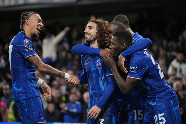 Chelsea's Marc Cucurella, second left, celebrates with teammates after scoring the opening goal of the game during the English Premier League soccer match between Chelsea and Brentford at Stamford Bridge in London, Sunday, Dec. 15, 2024. (AP Photo/Kin Cheung)