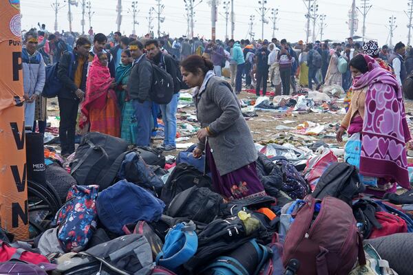 Hindu devotees search for their belongings after a stampede when Hindu devotees rushed to take a holy bath in the Sangam, the confluence of the Ganges, the Yamuna and the mythical Saraswati rivers, on "Mauni Amavasya" or new moon day during the Maha Kumbh festival in Prayagraj, India, Wednesday, Jan. 29, 2025. (AP Photo/Deepak Sharma)