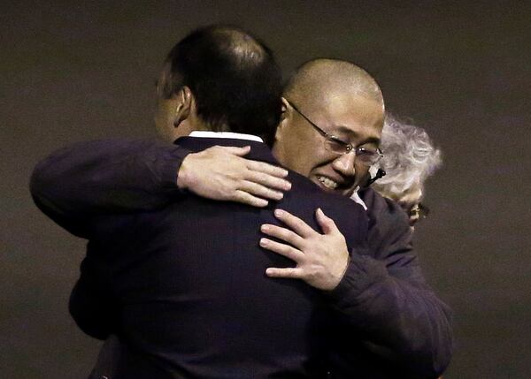 FILE - Kenneth Bae, right, who had been held in North Korea since 2012, is hugged following his arrival at Joint Base Lewis-McChord, Wash., Nov. 8, 2014, after he and fellow American Matthew Miller were freed during a top-secret mission. (AP Photo/Ted S. Warren, File)