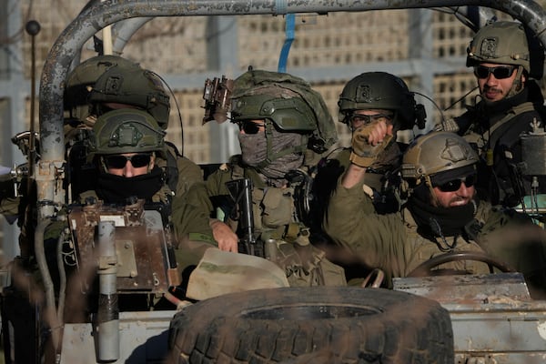 Israeli soldiers stand on an armoured vehicle after crossing the security fence near the so-called Alpha Line that separates the Israeli-controlled Golan Heights from Syria, in the town of Majdal Shams, Monday, Dec. 16, 2024. (AP Photo/Matias Delacroix)