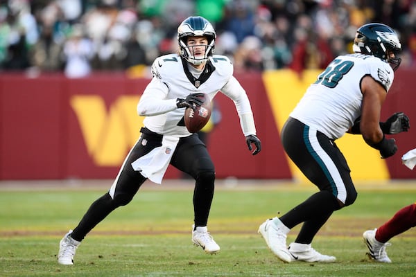 Philadelphia Eagles quarterback Kenny Pickett (7) looking downfield as he runs with the ball during the second half of an NFL football game against the Washington Commanders, Sunday, Dec. 22, 2024, in Landover, Md. (AP Photo/Nick Wass)