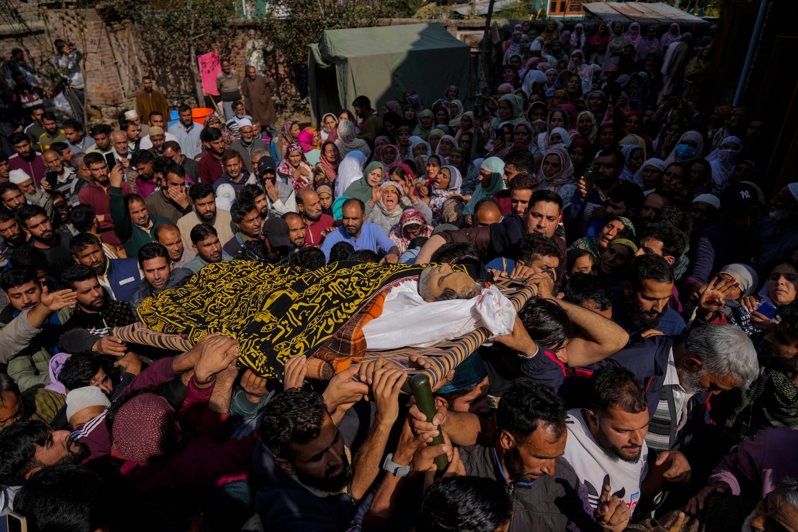 Villagers carry the body of Kashmiri doctor Shahnawaz who was among those killed when gunmen fired at people working on a strategic tunnel project in Indian-controlled Kashmir, during his funeral at Nadigam village, southwest of Srinagar, Monday, Oct. 21, 2024. (AP Photo/Mukhtar Khan)