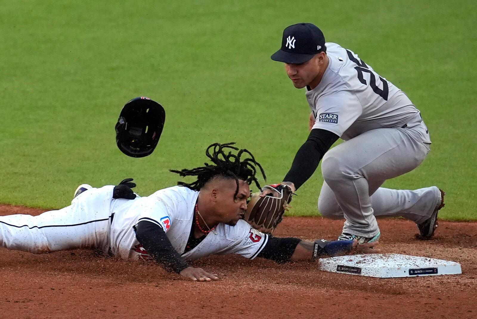 Cleveland Guardians' José Ramírez, right, steals second base as New York Yankees second baseman Gleyber Torres (25) reaches to tag him during the third inning in Game 3 of the baseball AL Championship Series Thursday, Oct. 17, 2024, in Cleveland.(AP Photo/Sue Ogrocki)