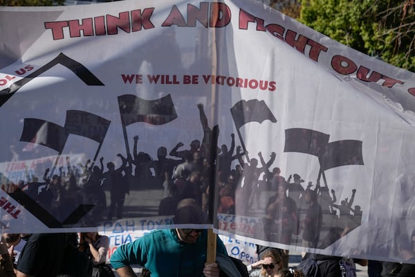 Protesters take part in rally, during a nationwide general strike organized by private and public sector unions demanding for better wages, in Athens, Greece, Wednesday, Nov. 20, 2024. (AP Photo/Thanassis Stavrakis)