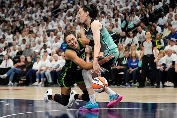 FILE -Minnesota Lynx forward Napheesa Collier and New York Liberty forward Breanna Stewart, right, battle for a loose ball during the second half of Game 4 of a WNBA basketball final playoff series, Oct. 18, 2024, in Minneapolis. (AP Photo/Abbie Parr, File)