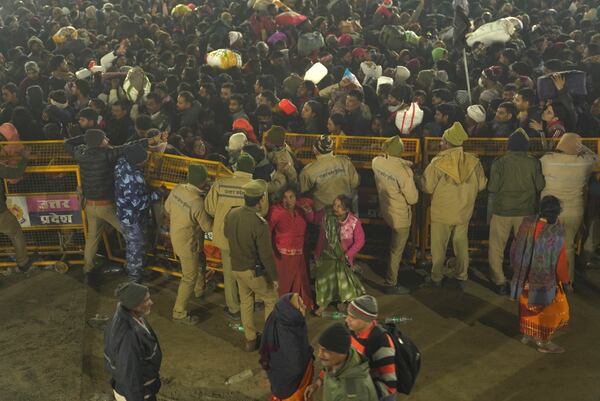 Hindu devotees speak with a policeman at the site of a stampede on the Sangam, the confluence of the Ganges, the Yamuna and the mythical Saraswati rivers, on "Mauni Amavasya" or new moon day during the Maha Kumbh festival, in Prayagraj, Uttar Pradesh, India, Wednesday, Jan. 29, 2025. (AP Photo)