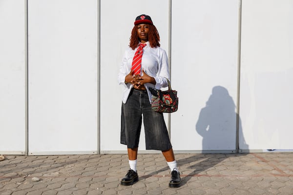 A woman dressed in second-hand clothes attends a thrift and an upcycle show in Accra, Ghana, Sunday, Oct. 27, 2024. (AP Photo/Misper Apawu)