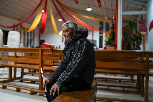 Hermogenes Cifuentes Arriaga, 86, waits to join a procession honoring the Black Christ of Esquipulas the night before its feast day in Esquipulas Palo Gordo, in Guatemala's San Marcos department, Tuesday, Jan. 14, 2025. (AP Photo/Moises Castillo)