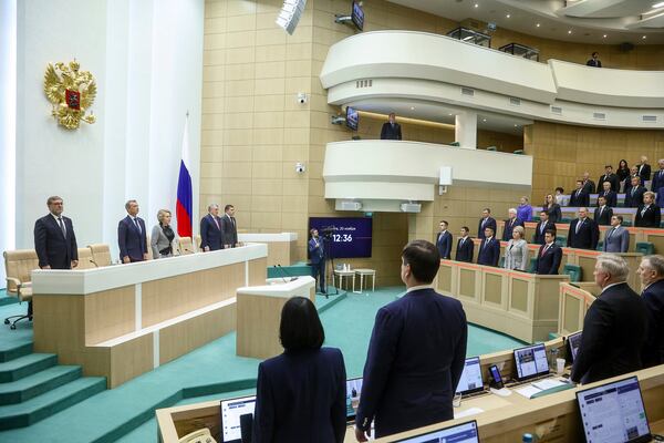 In this photo released by the Federation Council of The Federal Assembly of the Russian Federation Press Service, lawmakers of Federation Council of the Federal Assembly of the Russian Federation listen to the national anthem prior to a session in Moscow, Wednesday, Nov. 20, 2024. (The Federation Council of The Federal Assembly of The Russian Federation Press Service via AP)