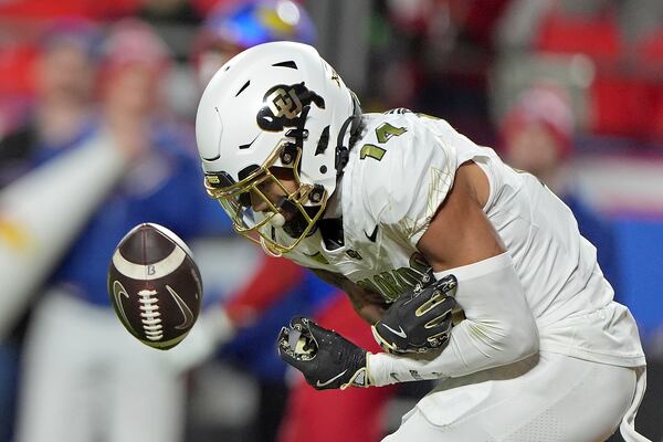 Colorado wide receiver Will Sheppard looses control the ball after a pass was broken up by Kansas cornerback Cobee Bryant (2) during the second half of an NCAA college football game, Saturday, Nov. 23, 2024, in Kansas City, Mo. (AP Photo/Charlie Riedel)