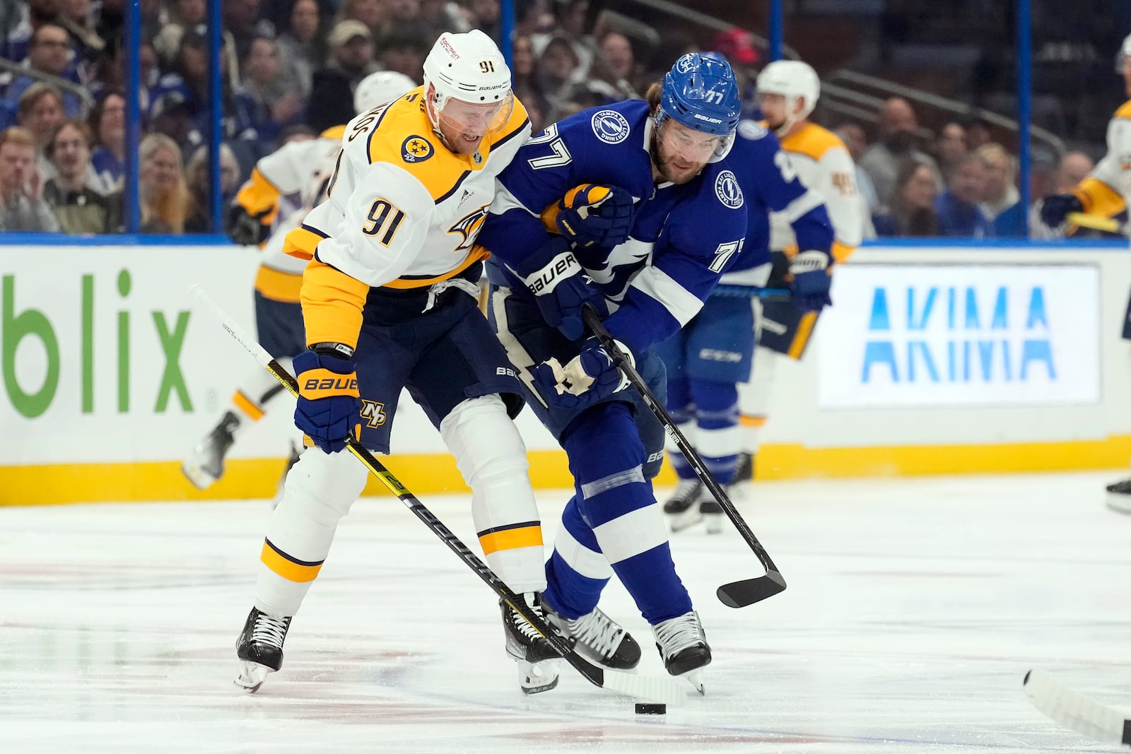 Nashville Predators center Steven Stamkos (91) and Tampa Bay Lightning defenseman Victor Hedman (77) battle for a loose puck during the first period of an NHL hockey game Monday, Oct. 28, 2024, in Tampa, Fla. (AP Photo/Chris O'Meara)