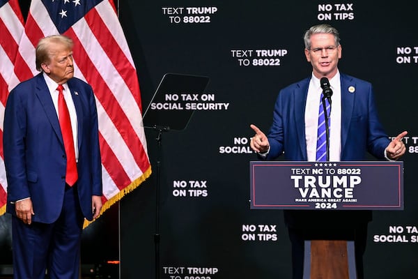 FILE - Republican presidential nominee former President Donald Trump, left, listens as investor Scott Bessent speaks on the economy in Asheville, N.C., Aug. 14, 2024. (AP Photo/Matt Kelley, File)