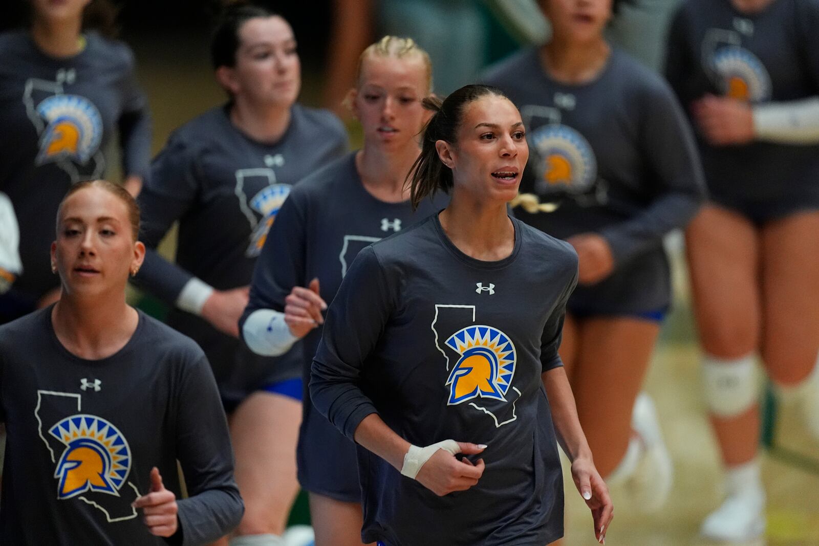 San Jose State players warm up before facing Colorado State in an NCAA college volleyball match Thursday, Oct. 3, 2024, in Fort Collins, Colo. (AP Photo/David Zalubowski)