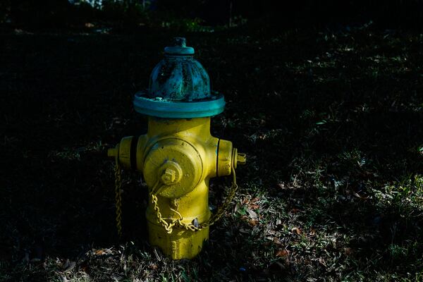 FILE - A beam of sunlight streams over a fire hydrant on Dec. 6, 2023, in Prichard, Ala., which loses 60% of its treated drinking water. (AP Photo/Brynn Anderson, File)