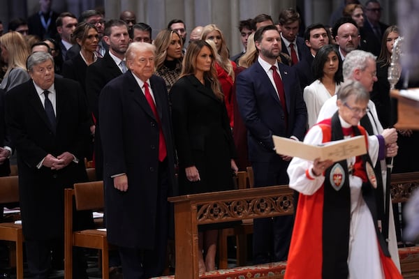 President Donald Trump, from front row left, first lady Melania Trump, Vice President JD Vance and his wife Usha Vance look on as Rev. Mariann Budde, right, arrives at the national prayer service at the Washington National Cathedral, Tuesday, Jan. 21, 2025, in Washington. (AP Photo/Evan Vucci)