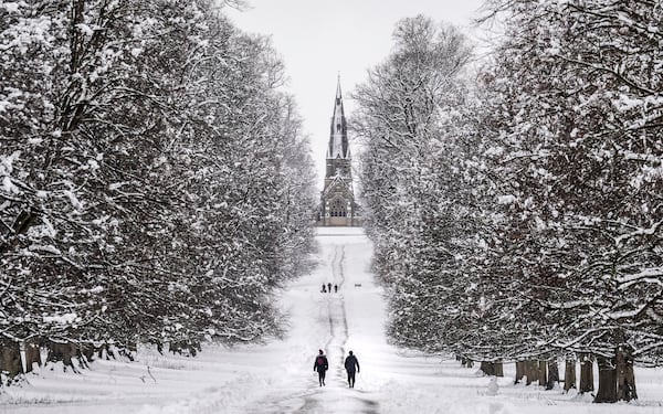 People walk in the snow in Studley Royal park in Ripon, North Yorkshire, England, Sunday, Jan. 5, 2025. (Danny Lawson/PA via AP)