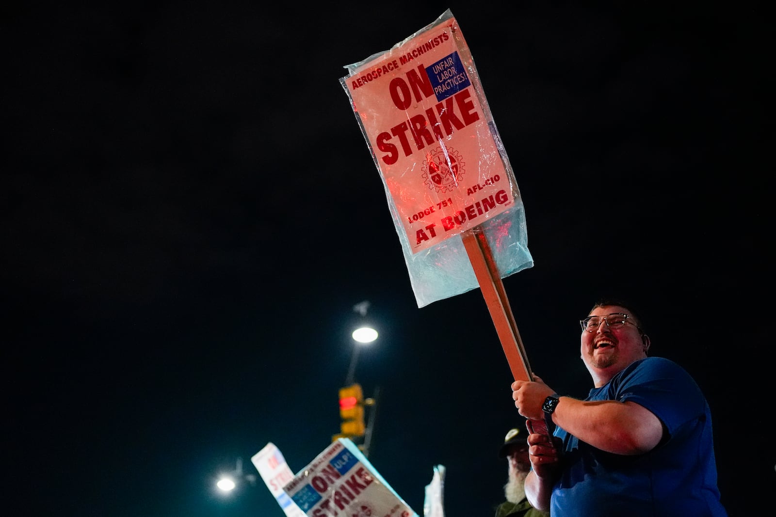 Machinist AJ Nelson, who has worked for Boeing for six years, works the picket line after union members voted to reject a new contract offer from the company, Wednesday, Oct. 23, 2024, in Renton, Wash. (AP Photo/Lindsey Wasson)