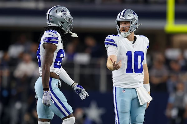 Dallas Cowboys quarterback Cooper Rush (10) and wide receiver CeeDee Lamb walk off the field after Rush threw an interception against the Houston Texans during the first half of an NFL football game, Monday, Nov. 18, 2024, in Arlington, Texas. (AP Photo/Gareth Patterson)