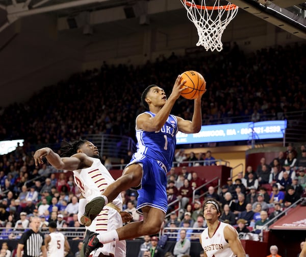 Duke guard Caleb Foster (1) lays up the ball in front of Boston College forward Jayden Hastings (22) during the first half of an NCAA college basketball game Saturday, Jan. 18, 2025, in Boston. (AP Photo/Mark Stockwell)